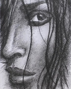 Framed black and white drawing of a face on a textured white background